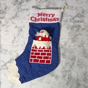 Blue & Red Christmas Stocking with Santa Design with the words “Merry Christmas”